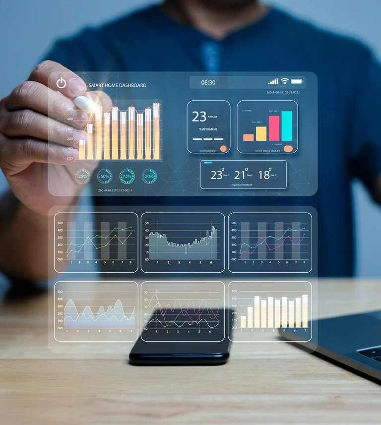 “Person interacting with a&nbsp;smart home dashboard projected above a&nbsp;smartphone, displaying various charts and data visualizations