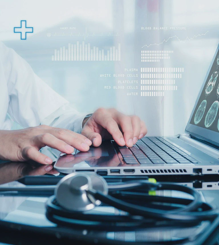 Laptop in a&nbsp;medical environment with a&nbsp;stethoscope and blood data visualizations